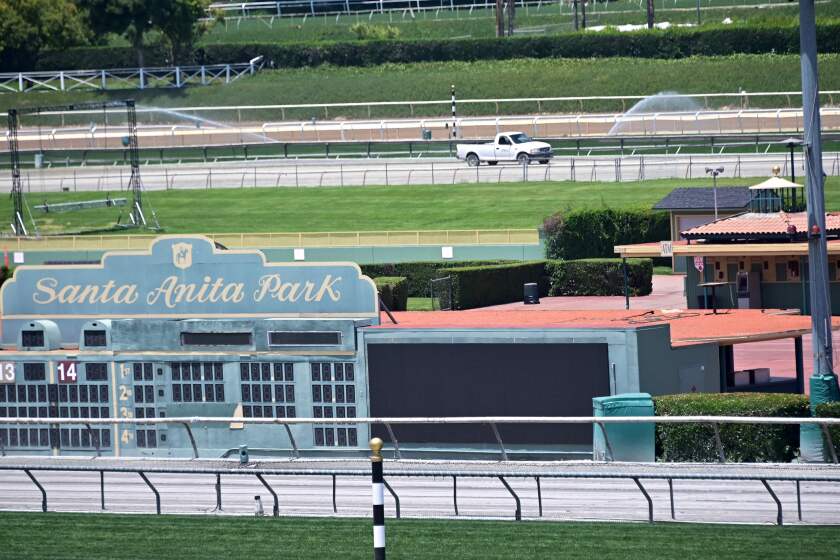 (FILES) In this file photo taken on June 10, 2019 a vehicle circles the track at Santa Anita horse racing park in Arcadia, California. - California's famed Santa Anita Park faced fresh scrutiny on January 20, 2020 after three horses died over the weekend at the racetrack. Santa Anita officials confirmed that a four-year-old gelding which had been training at the track on Sunday had been euthanised after suffering undisclosed injuries in an accident. (Photo by Frederic J. BROWN / AFP) (Photo by FREDERIC J. BROWN/AFP via Getty Images) ** OUTS - ELSENT, FPG, CM - OUTS * NM, PH, VA if sourced by CT, LA or MoD **