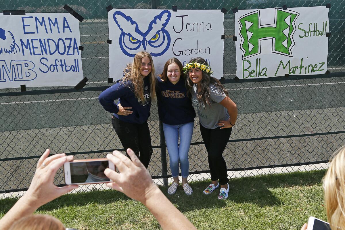 Edison softball players Emma Mendoza, Jenna Gorden and Izabella Martinez pose for a photo at a spring signing day ceremony.