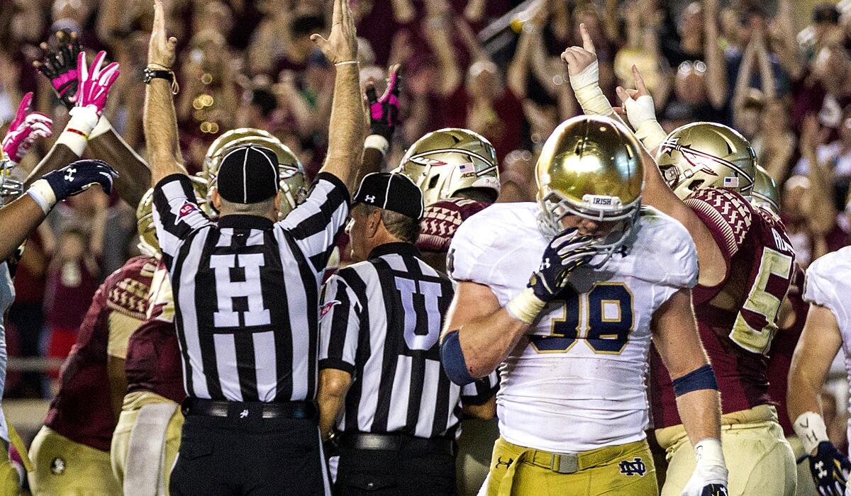 Notre Dame safety Joe Schmidt walks away as officials signal a Florida State touchdown in the third quarter Saturday night in Tallahassee.