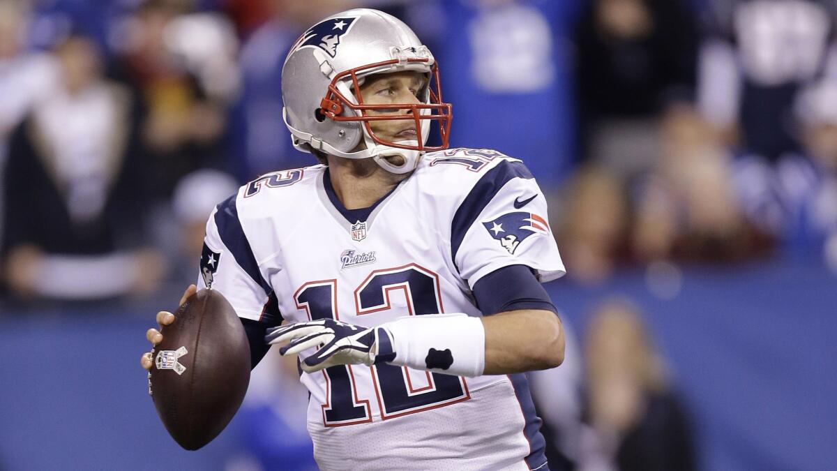 New England Patriots Tom Brady looks to pass during a game against the Indianapolis Colts in November 2014. Brady was suspended four games by the NFL on Monday.