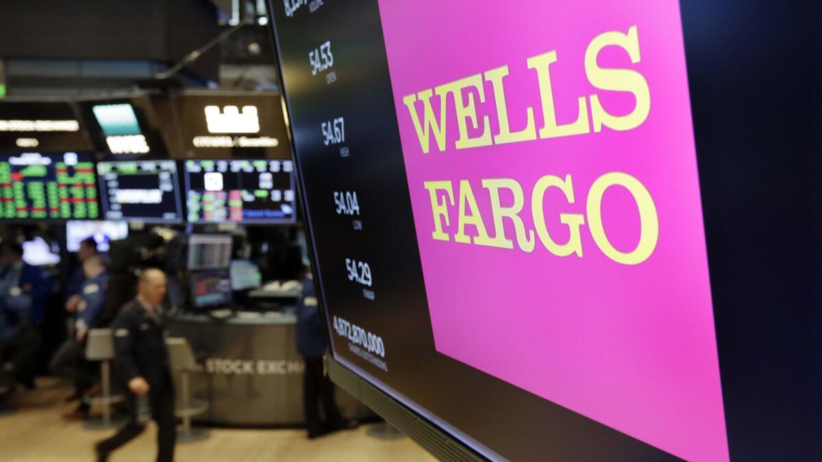 The logo for Wells Fargo appears above a trading post on the floor of the New York Stock Exchange this month.