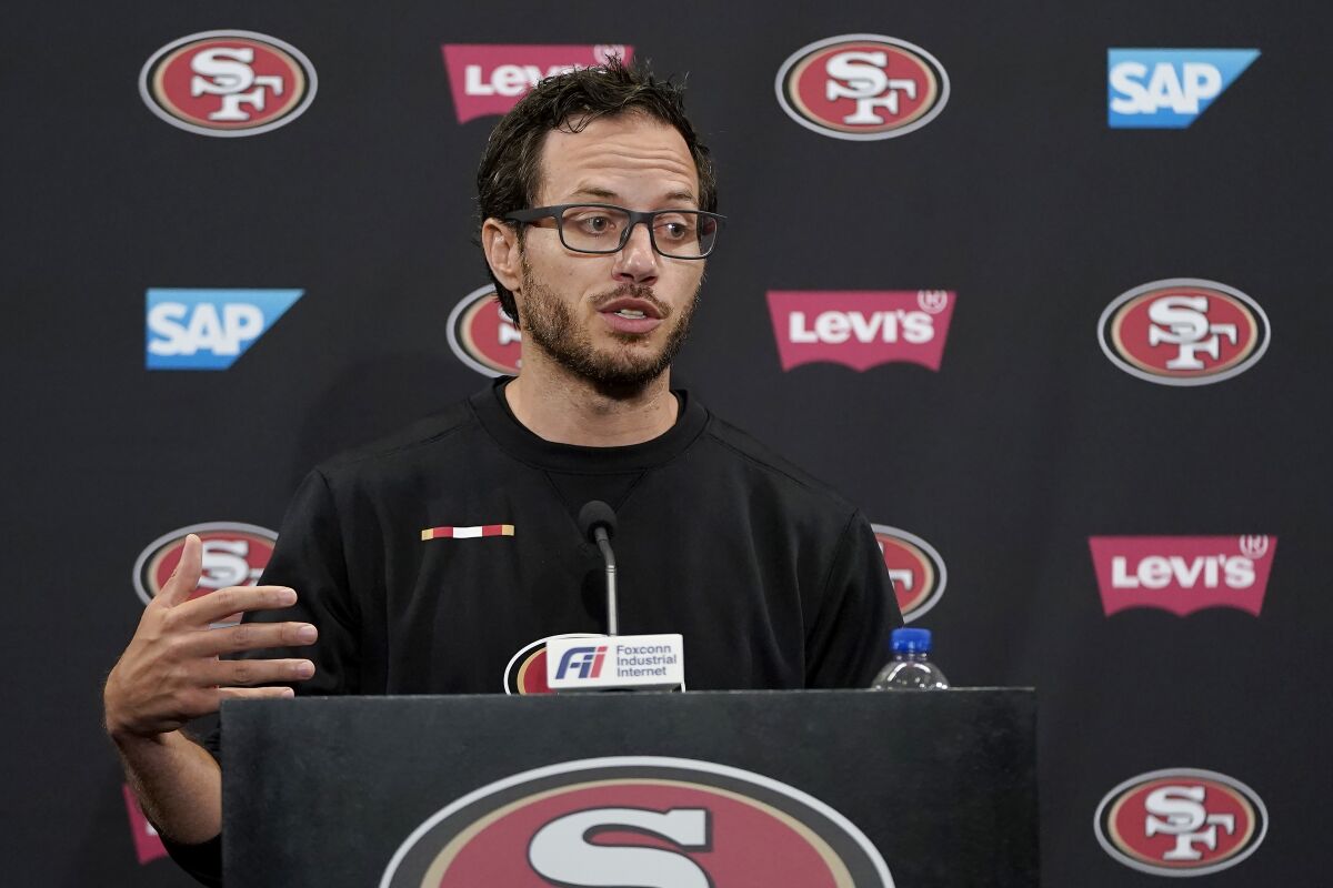 FILE - San Francisco 49ers offensive coordinator Mike McDaniel speaks during a news conference at NFL football training camp in Santa Clara, Calif., Thursday, July 29, 2021. On Sunday, Feb. 6, 2022, the Miami Dolphins announced they have hired McDaniel as their new coach, making him the first minority candidate to get hired so far this offseason. (AP Photo/Jeff Chiu, File)