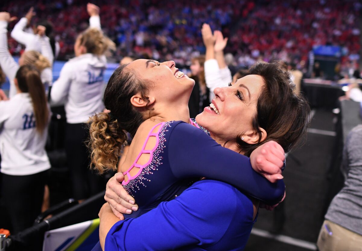 UCLA's Katelyn Ohashi jumps into the arms of coach Valorie Kondos Field.