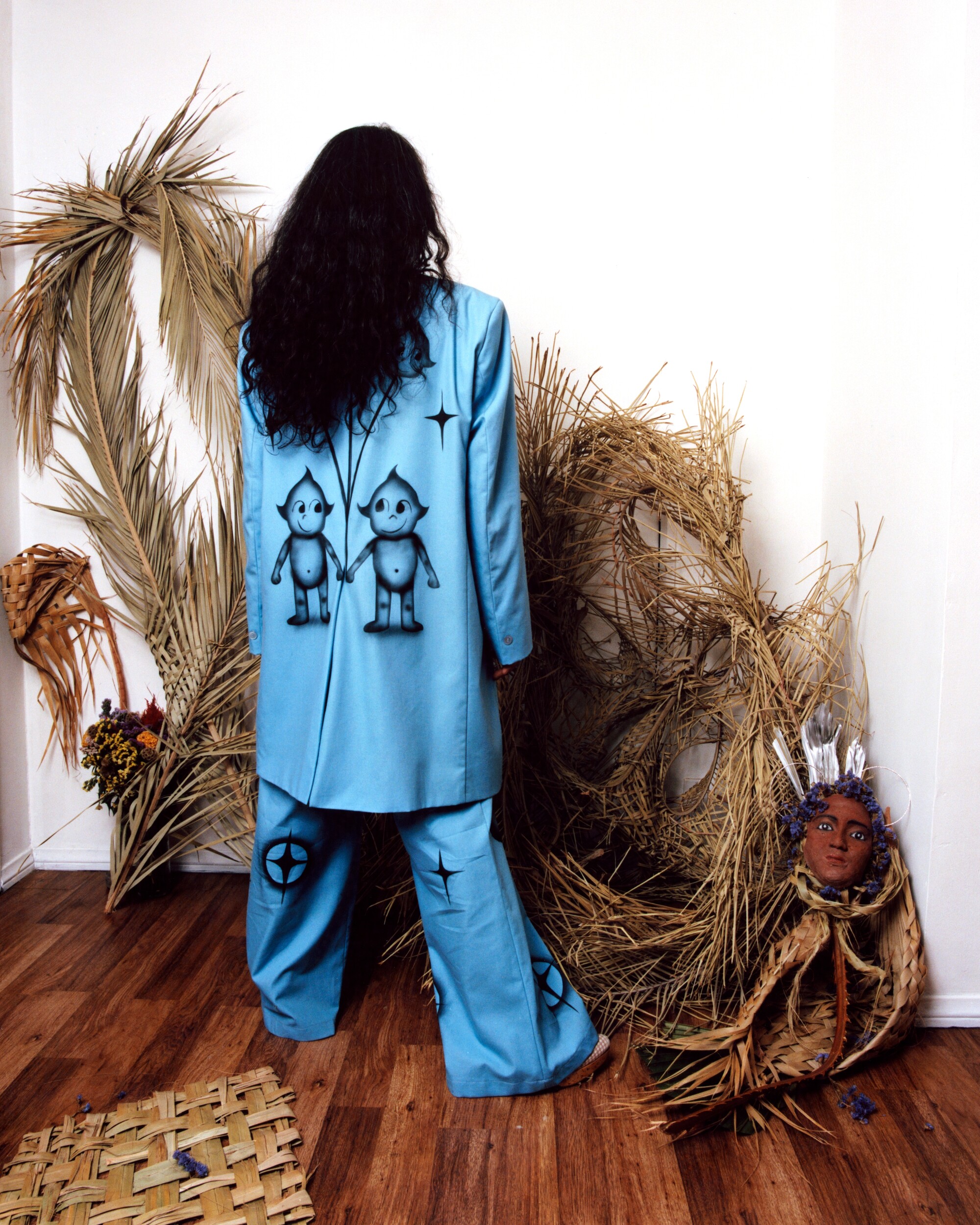 Photograph of artist Maria Maea, pictured in custom suit by Julissa Aaron.