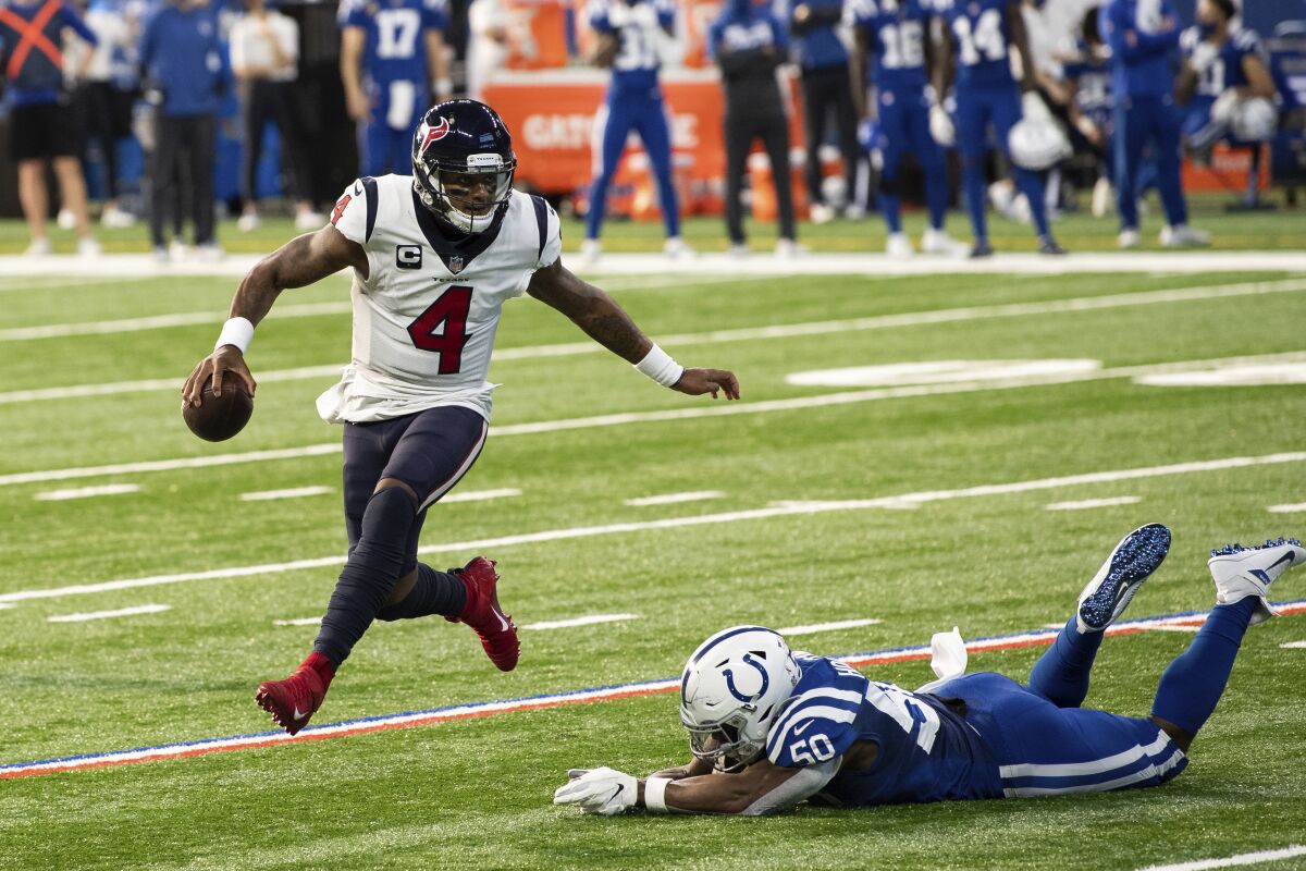 Houston Texans quarterback Deshaun Watson avoids diving Indianapolis Colts defensive end Justin Houston.