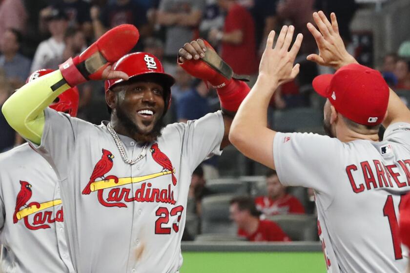 St. Louis Cardinals left fielder Marcell Ozuna (23) celebrates his two RBI single against the Atlanta Braves in the ninth inning during Game 1 of a best-of-five National League Division Series, Thursday, Oct. 3, 2019, in Atlanta. (AP Photo/John Bazemore)
