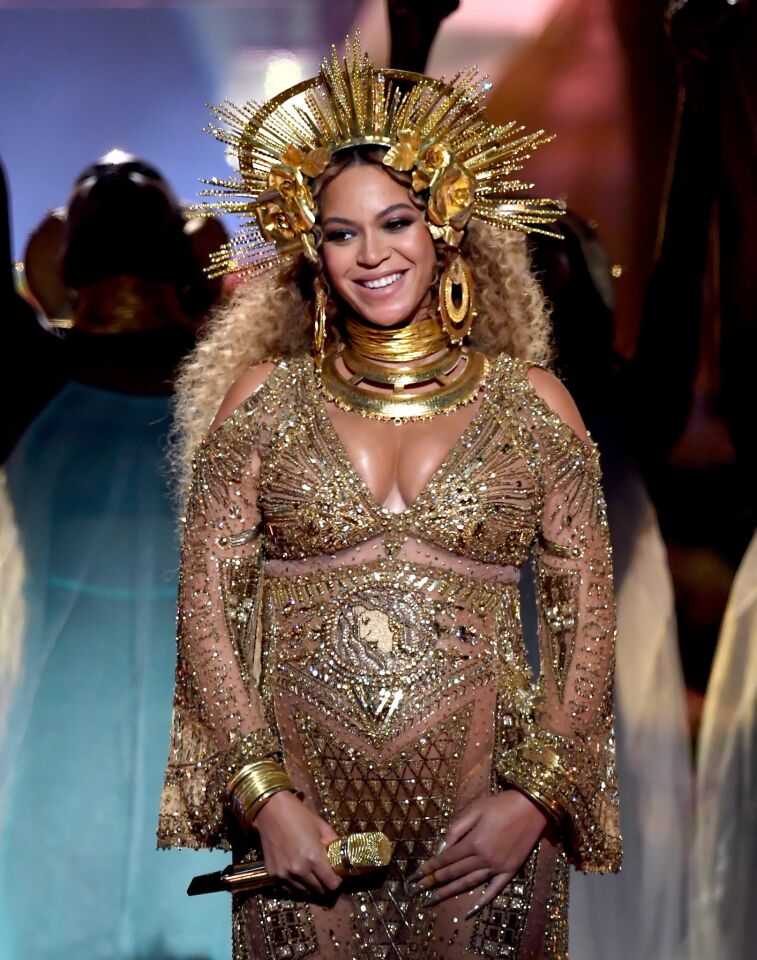 Beyonce smiles as the audience applauds.