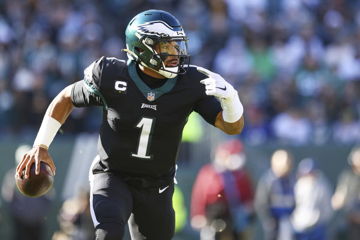 The Eagles' Jalen Hurts looks to pass the ball.