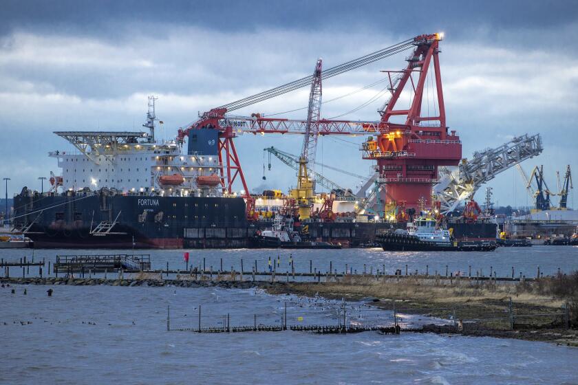 FILE - A tugboats get into position on the Russian pipe-laying vessel "Fortuna", being used for construction work on the German-Russian Nord Stream 2 gas pipeline in the Baltic Sea, in the port of Wismar, Germany, on Jan 14, 2021. European leaders are turning to Africa for more natural gas as the EU tries to replace Russian exports amid the war in Ukraine. (Jens Buettner/dpa via AP, File)