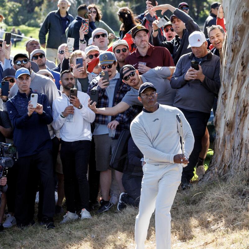 Tiger Woods hits out of the rough on the 18th hole at Riviera Country Club.