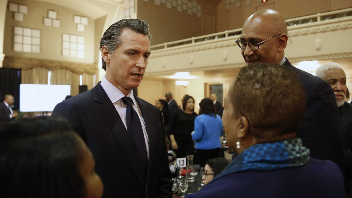 Gov. Gavin Newsom, second from left, talks with attendees at the California Legislative Black Caucus Martin Luther King Jr., breakfast, Thursday, Jan. 17 in Sacramento.