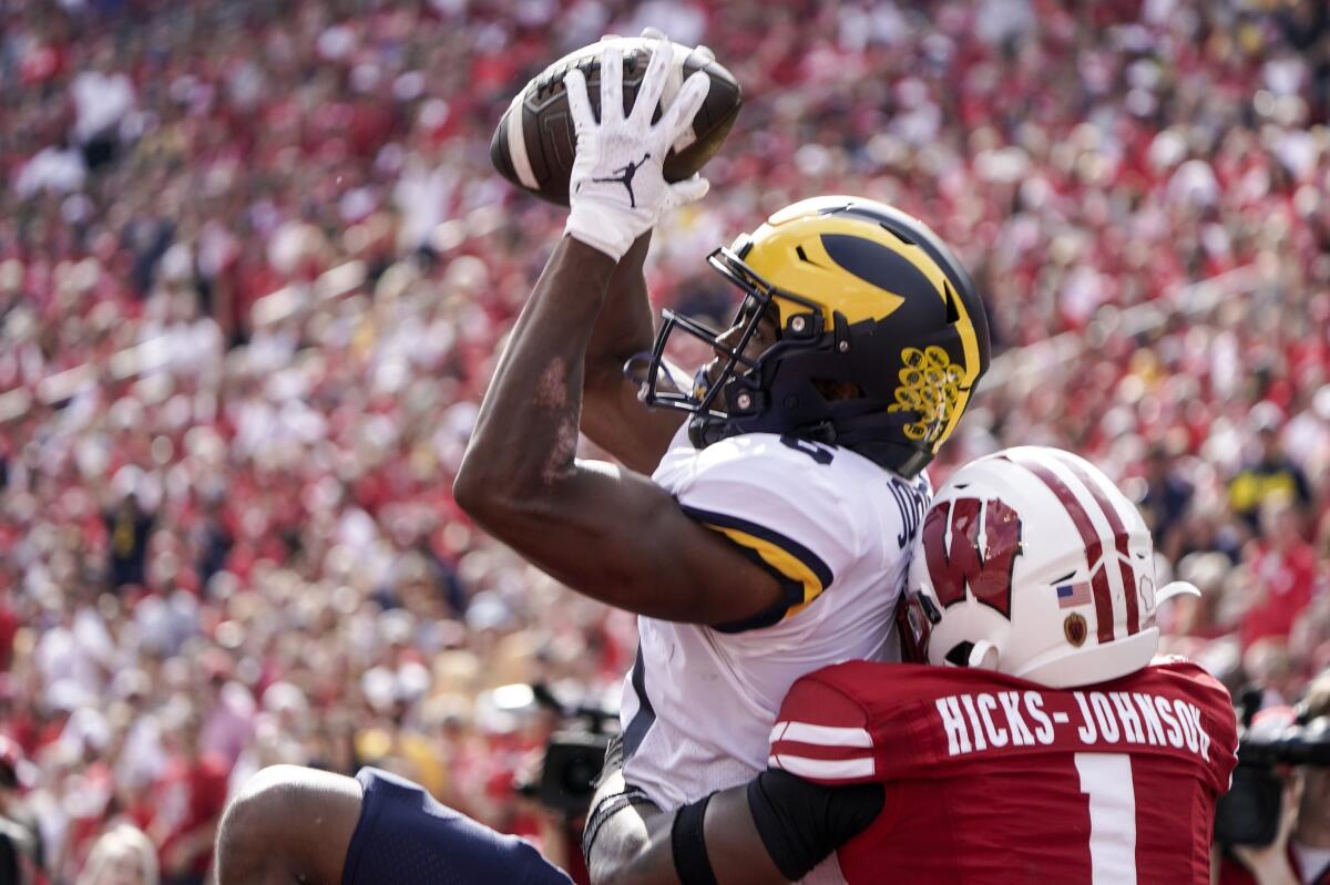 Michigan's Cornelius Johnson catches a touchdown pass against Wisconsin's Faion Hicks on Oct. 2, 2021.