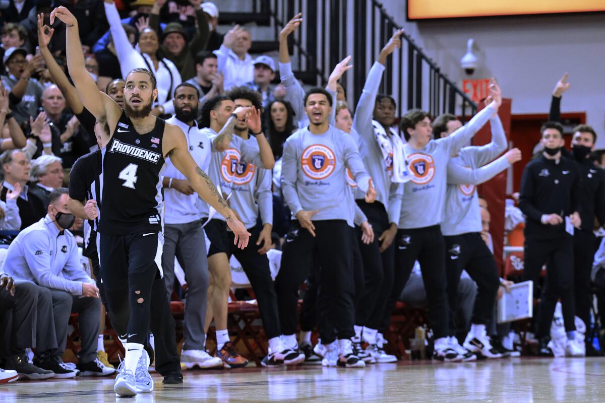 Providence guard Jared Bynum (4) reacts to his 3-point basket against St. John's during the second half of an NCAA college basketball game Tuesday, Feb. 1, 2022, in New York. (AP Photo/Jessie Alcheh)