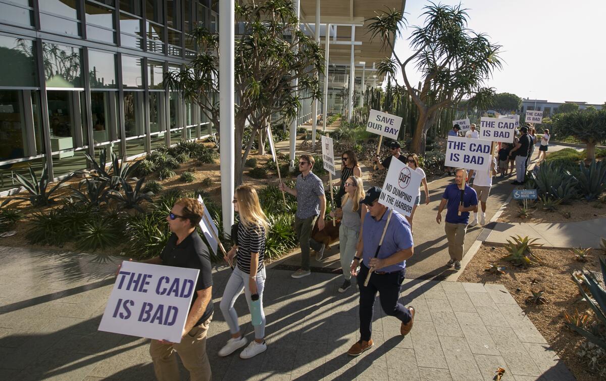 Friends of Newport Harbor march to Newport Beach City Council chambers Tuesday.