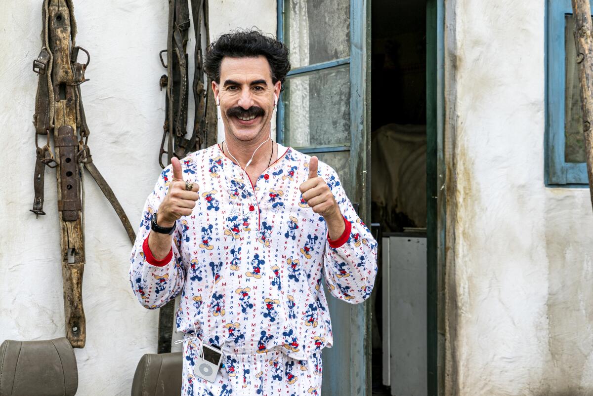 Borat gives two thumbs up while listening to an iPod