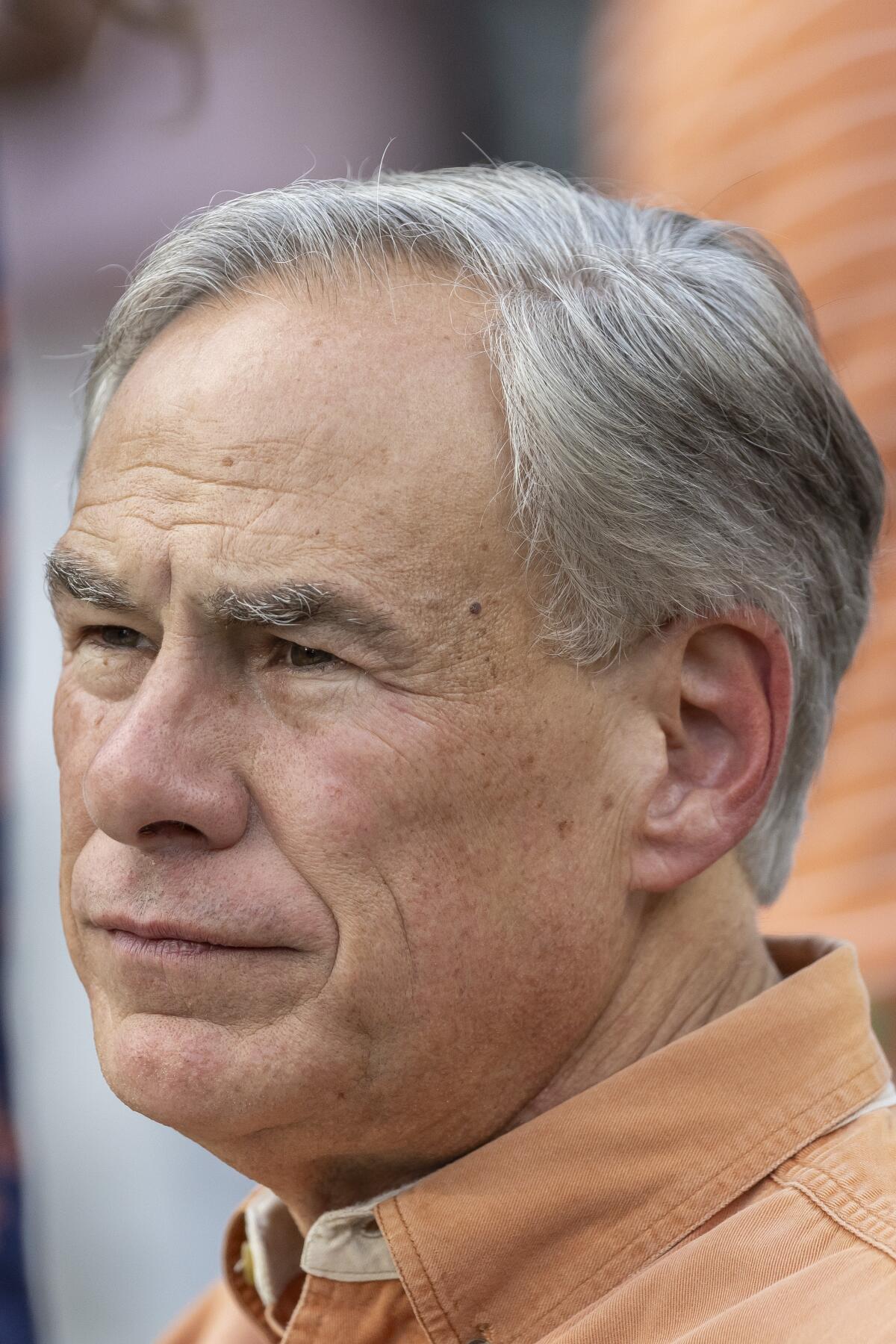 Texas Gov. Greg Abbott visits the field during warmups before an NCAA college football game between Texas and Alabama, Saturday, Sept. 9, 2023, in Tuscaloosa, Ala. (AP Photo/Vasha Hunt)