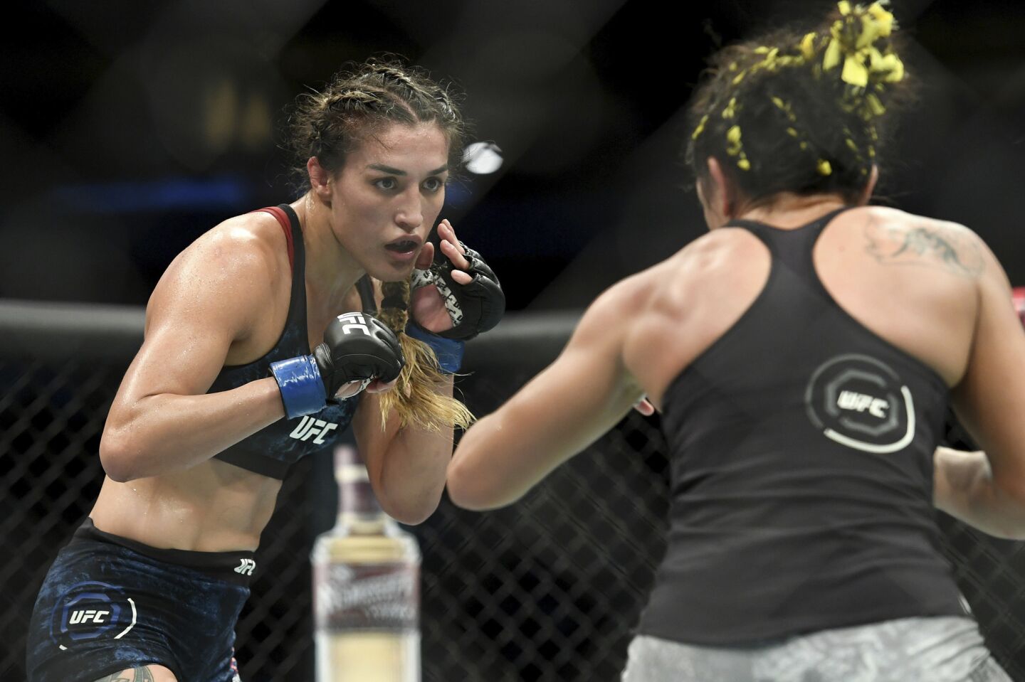Tatiana Suarez, left, spars with Carla Esparza during their strawweight mixed martial arts bout at UFC 228 on Saturday, Sept. 8, 2018, in Dallas. (AP Photo/Jeffrey McWhorter)