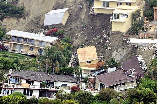 A hillside in the Bluebird Canyon area of Laguna Beach, saturated by a winter season of unusually heavy rains, gave way Wednesday morning, destroying at least nine homes and damaging more than 20 others.
