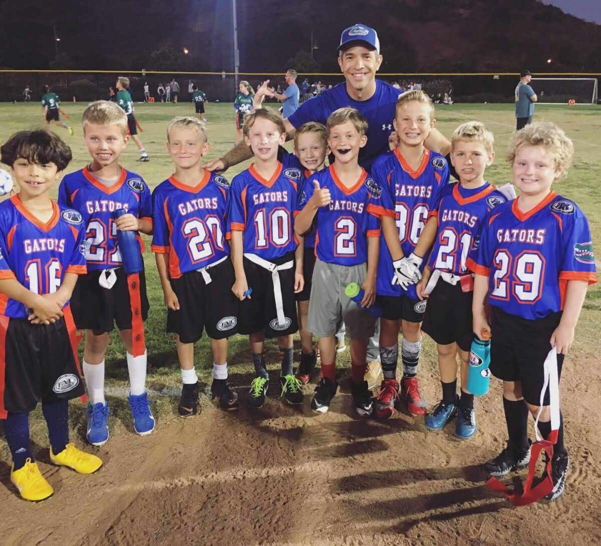 Fox 5 San Diego anchor and debut author Andrew Luria is shown coaching the flag football team of his son, Nathan (No. 2).