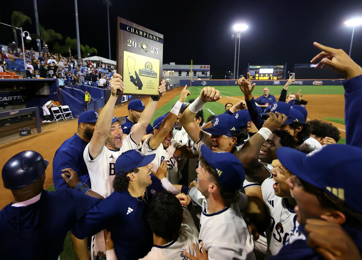 Coach Andy Rojo raises the championship plaque after St. John Bosco's 3-2 win over Santa Margarita.