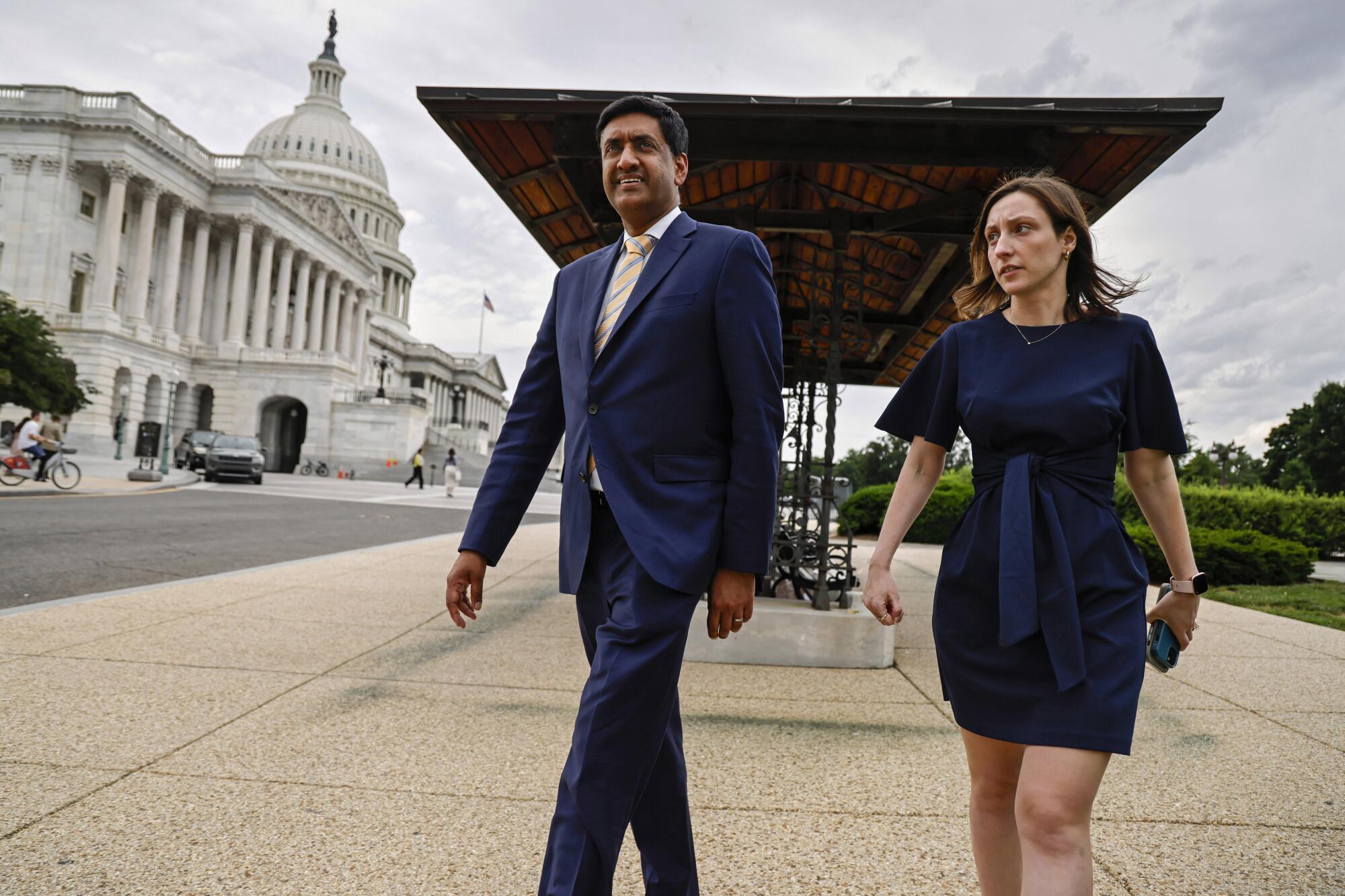 Rep. Ro Khanna, left, and aide Marie Baldassarre walking near the U.S. Capitol under a cloudy sky
