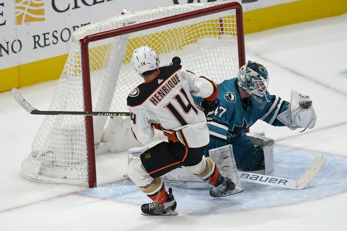 Ducks forward Adam Henrique scores past San Jose Sharks goaltender James Reimer in a shootout.