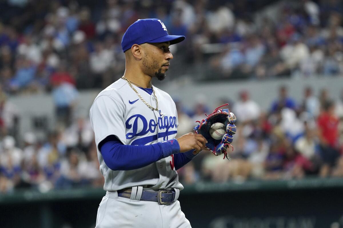 Dodgers second baseman Mookie Betts walks off the field during a game.