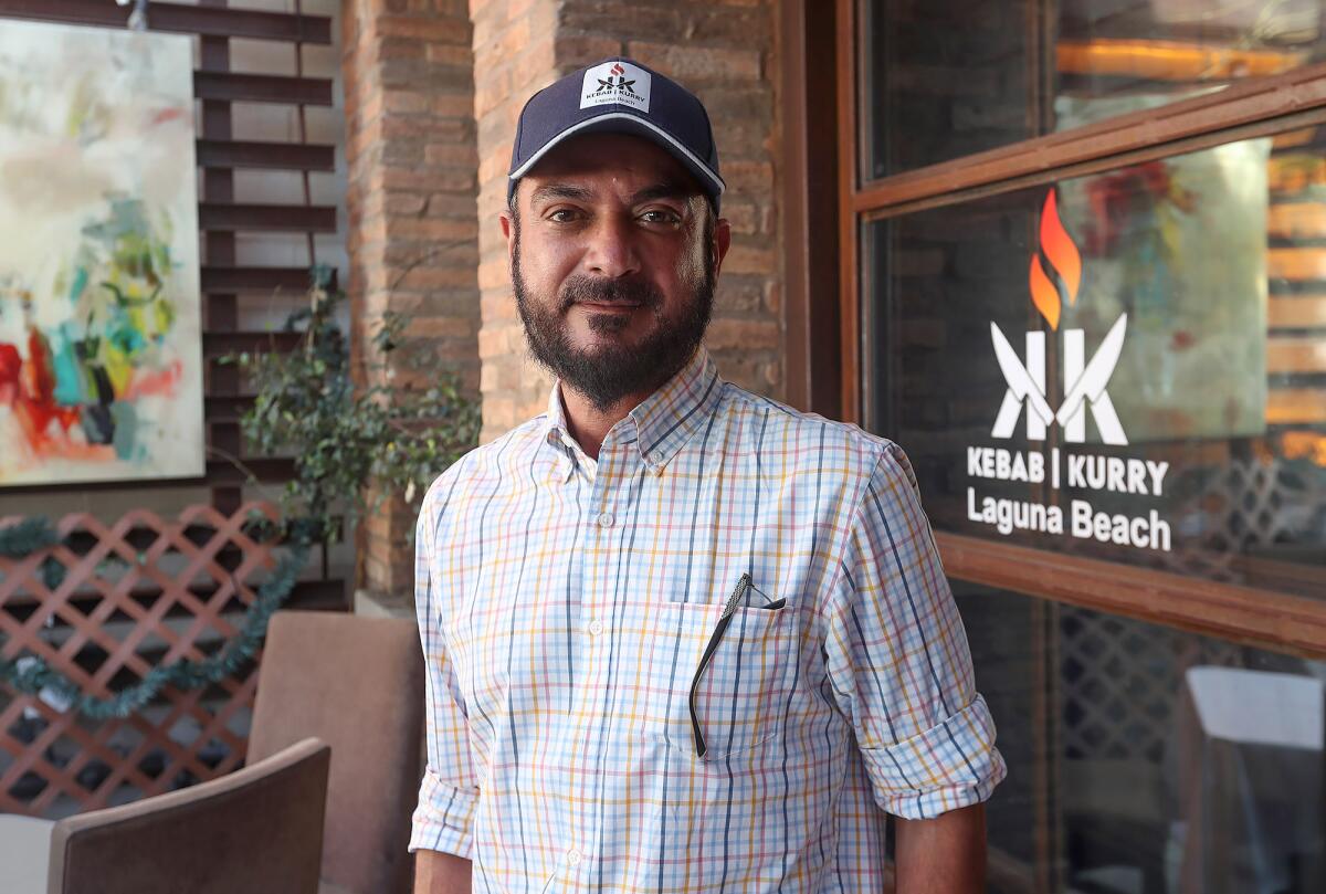 Majid Makri stands in the main dining room of Kebab Kari in Laguna Beach.