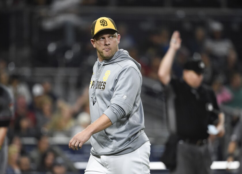 Andy Green walks off the field after arguing a call in the Padres' 9-0 loss to Diamondbacks on Friday night.