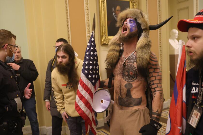 WASHINGTON, DC - JANUARY 06: Protesters interact with Capitol Police inside the U.S. Capitol Building on January 06, 2021 in Washington, DC. Congress held a joint session today to ratify President-elect Joe Biden's 306-232 Electoral College win over President Donald Trump. A group of Republican senators said they would reject the Electoral College votes of several states unless Congress appointed a commission to audit the election results. (Photo by Win McNamee/Getty Images)