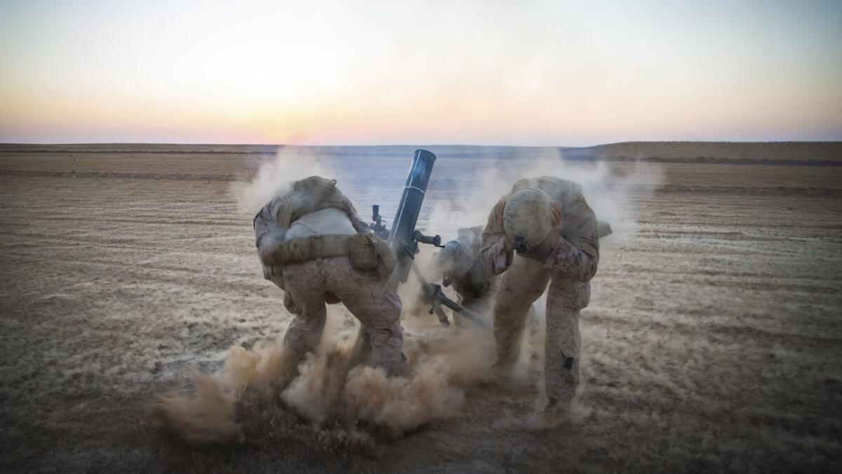 Marines with Weapons Company, 3rd Battalion, 7th Marine Regiment, fire mortars from an undisclosed location in Syria.