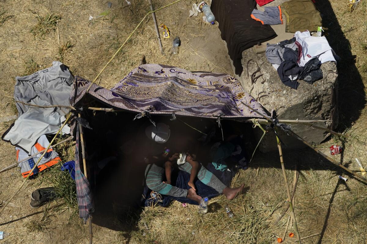 Haitian migrants use a makeshift shelter along the Rio Grande.