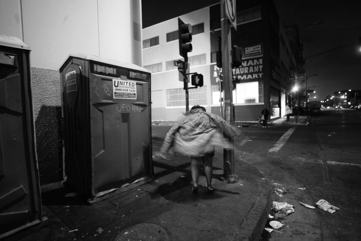 "Thick and Juicy," otherwise known as TJ, stands at 6th and San Julian streets in the skid row neighborhood in 2005. She said she worked and lived in the portable toilets, which later were removed. "I run this corner," she said.