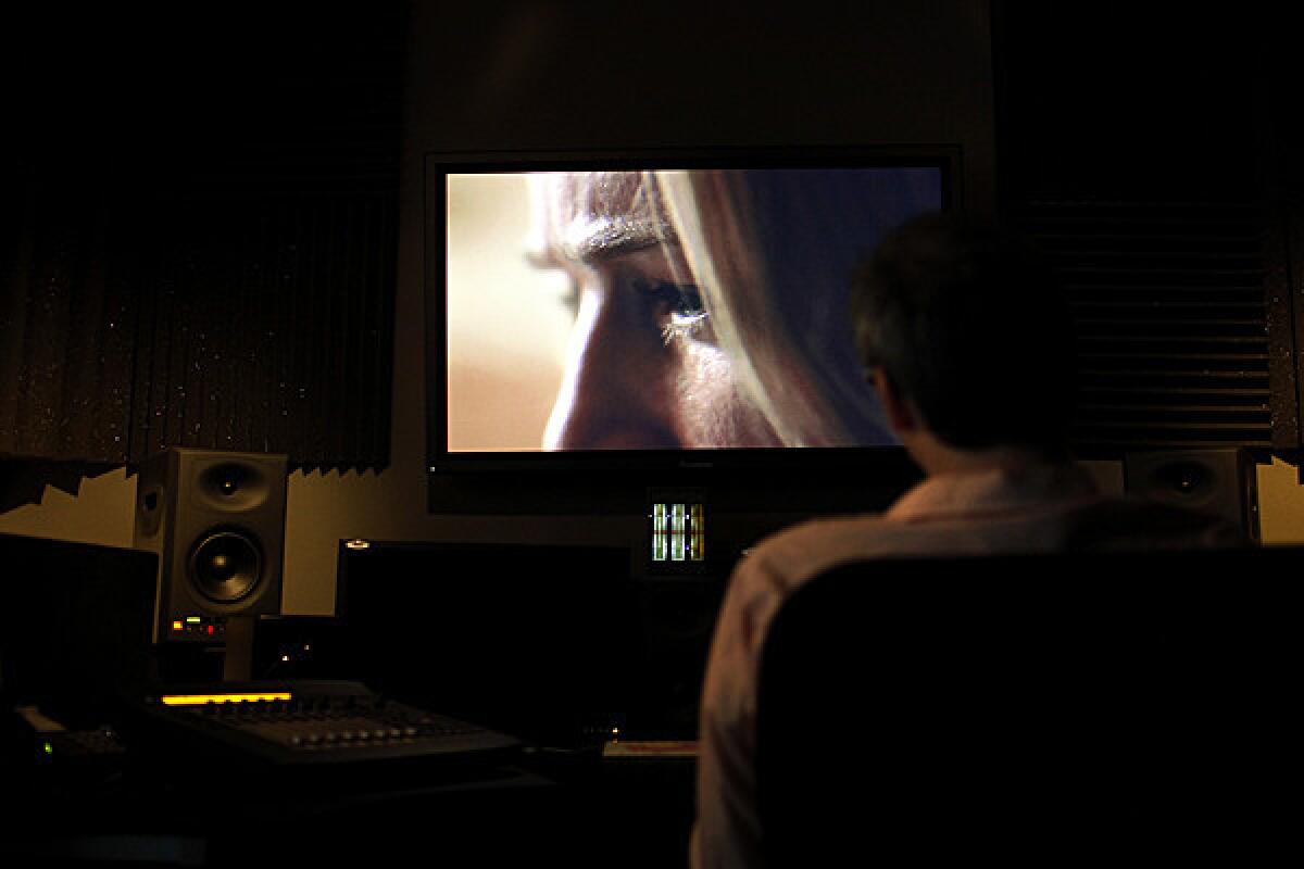 Writer and director Nicholas McCarthy watches his movie "The Pact," with lead actress Caity Lotz on screen, one last time at Secret Headquarters, a post¿production company for film and TV, in Culver City. Following the viewing, the film was shipped to Park City, Ut., for it's premier at the Sundance Film Festival.