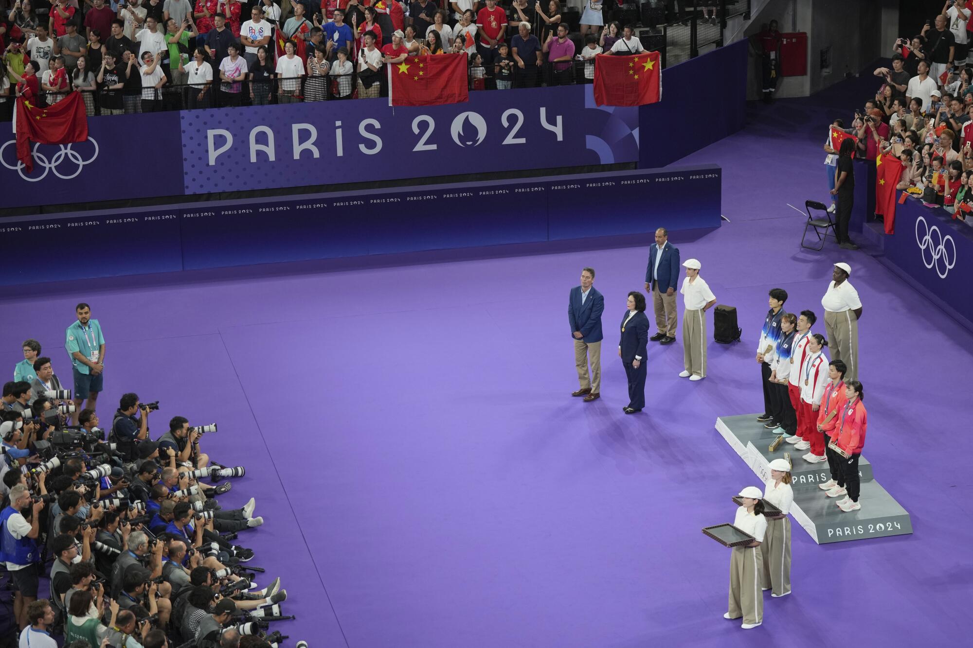 Athletes stand on the podium during the medal ceremony for mixed doubles badminton at the Paris Olympics on Friday.