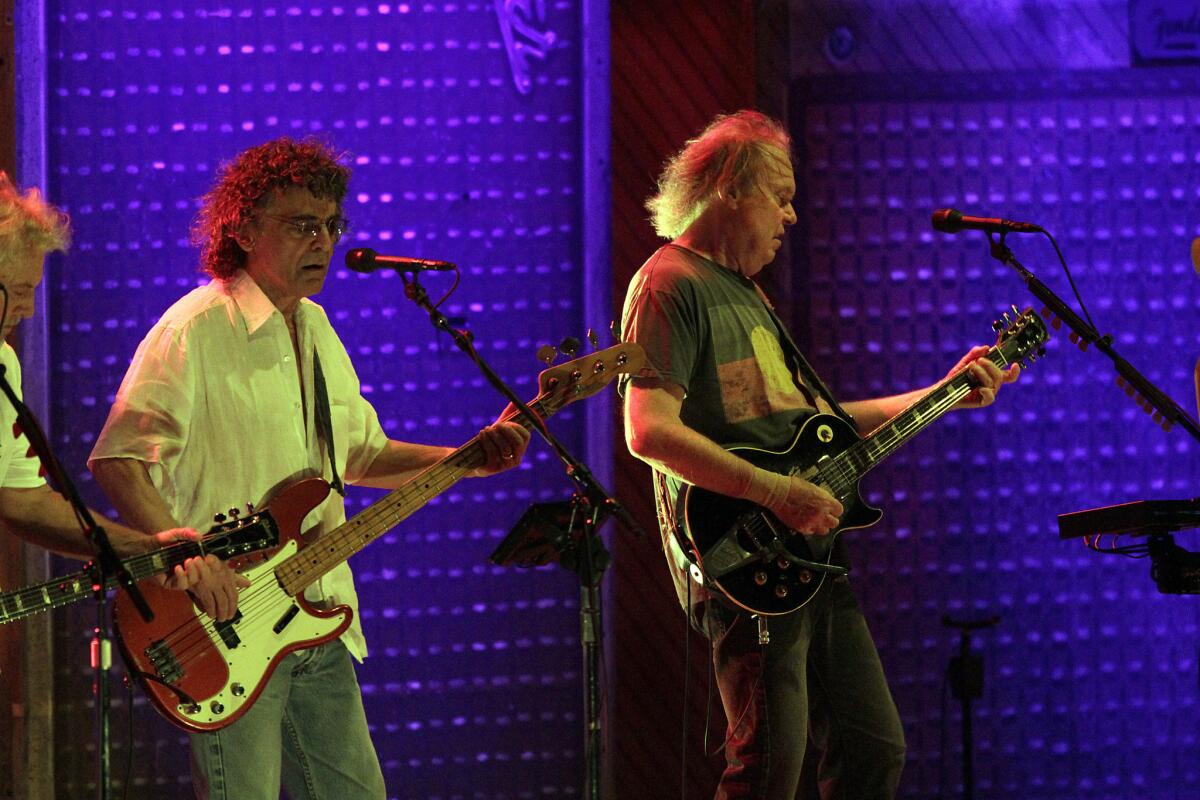 Bassist Billy Talbot, left, and Neil Young during a 2012 Crazy Horse performance at the Hollywood Bowl.