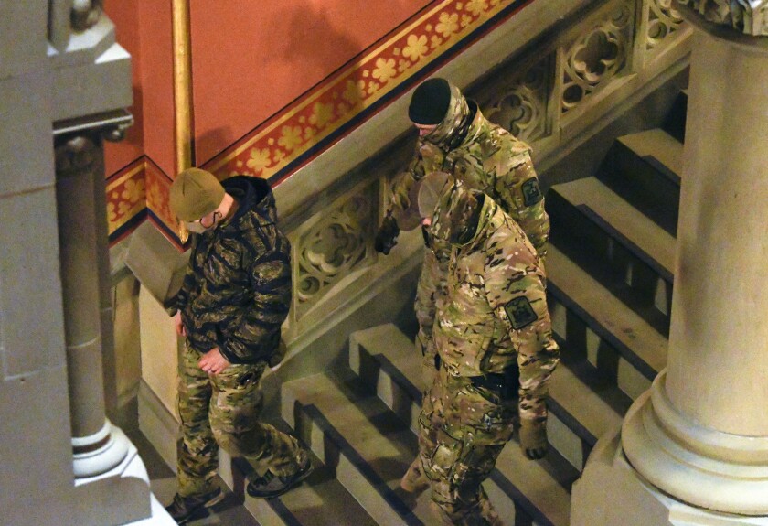 New York state Police wearing tactical gear patrol the hallways of the state Capitol prior to a planned President Trump protest rally ahead of the inauguration of President-elect Joe Biden and Vice President-elect Kamala Harris Sunday, Jan. 17, 2021, in Albany, N.Y. (AP Photo/Hans Pennink)