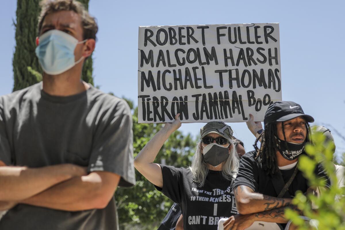 People rally outside L.A. County Supervisor Kathryn Barger's Lancaster office in June.