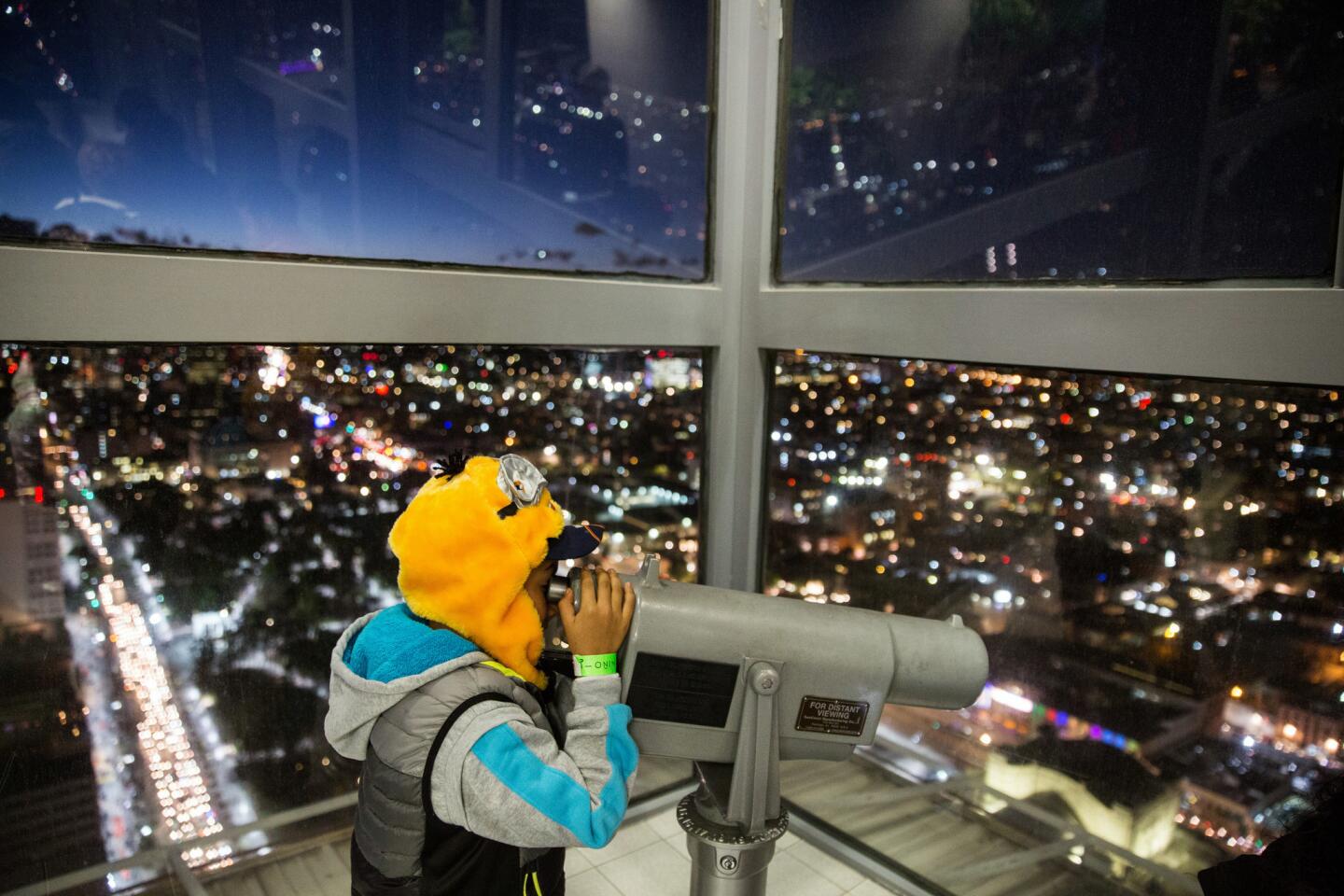 Alejandro Ruiz, 9, looks into the telescope at the top floors of Torre Latinoamericana in Mexico City.