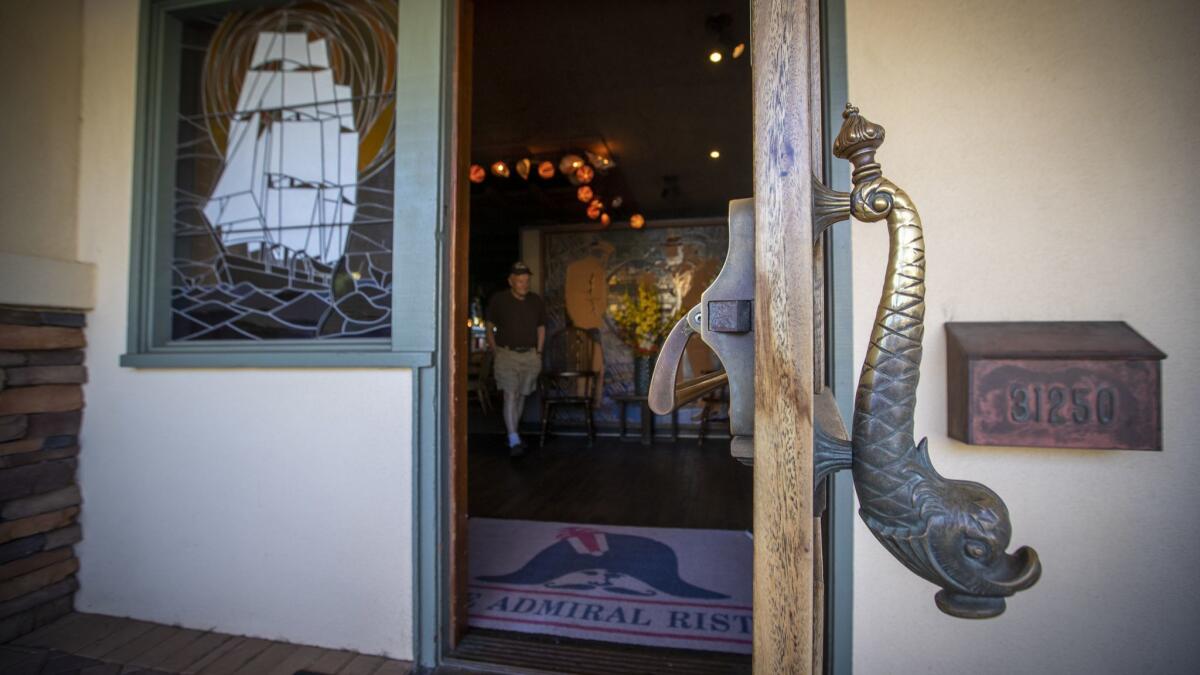 Stained-glass windows and door handle at the Admiral Risty restaurant reflect the restaurant's whaling decor.