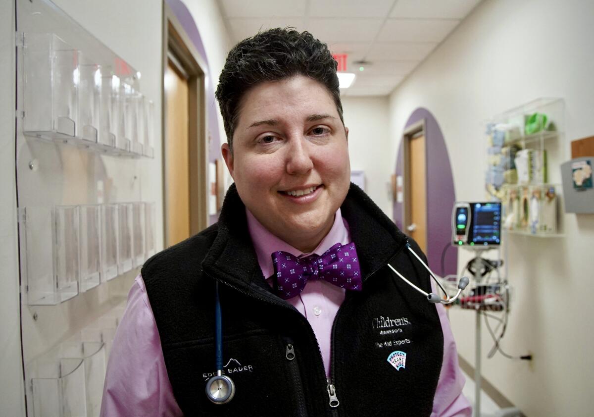 A smiling person with a stethoscope around their neck.