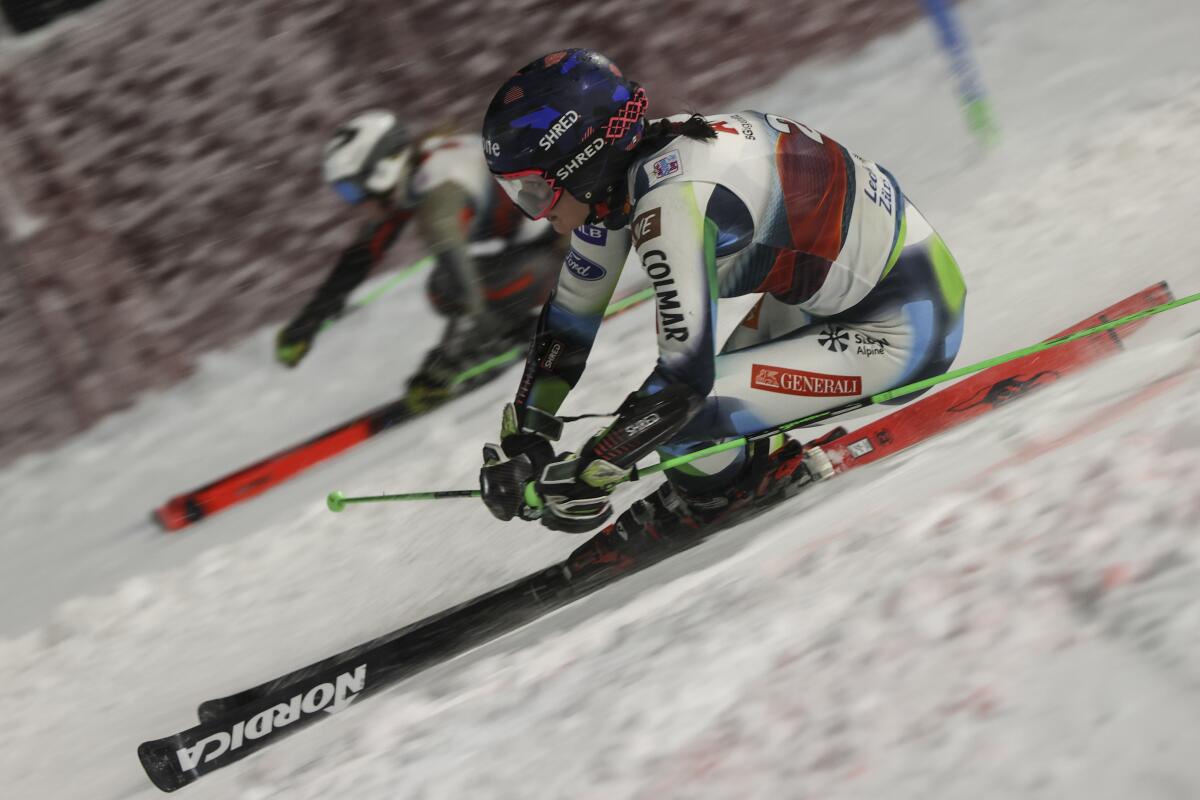 Slovenia's Andreja Slokar, foreground, competes alongside Norway's Thea Louise Stjernesund to win during an alpine ski, women's World Cup parallel event, in Lech/Zuers, Austria, Saturday, Nov. 13, 2021. (AP Photo/Alessandro Trovati)