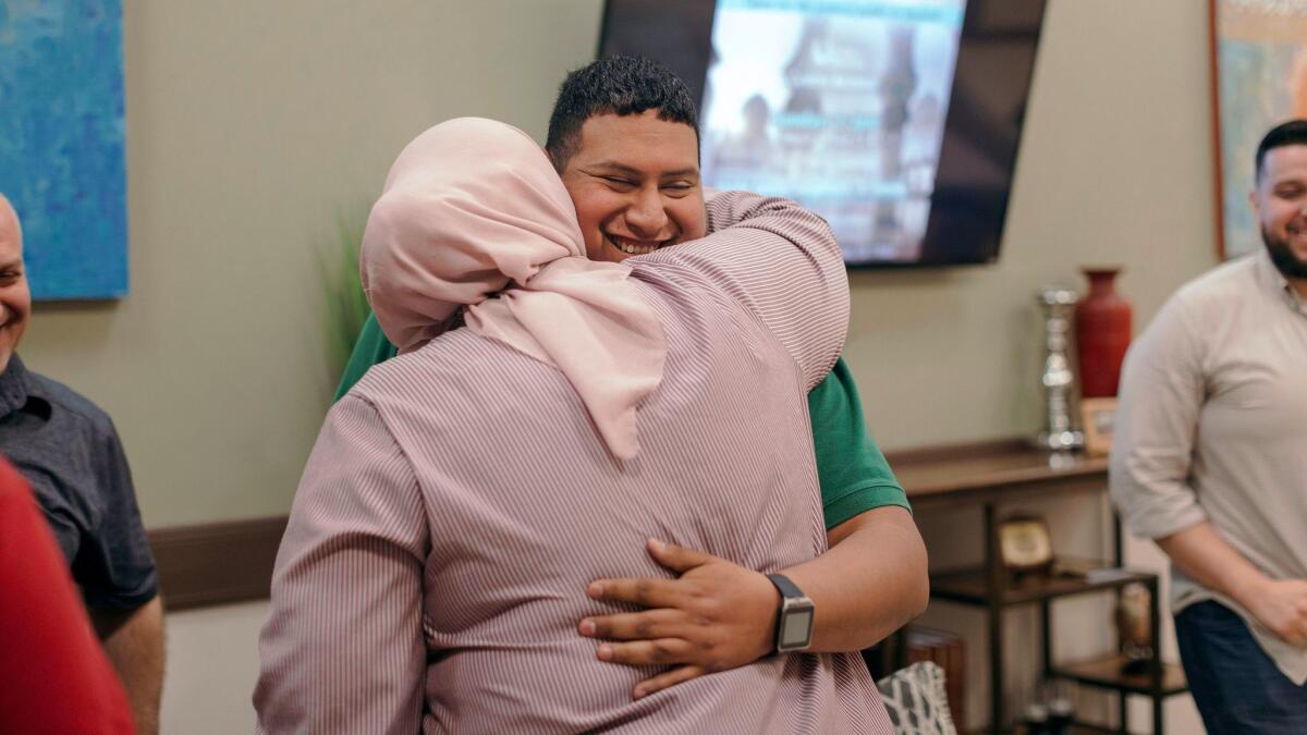 New member Armando Segura, 28, of Houston, embraces his sister following a short ceremony welcoming him to the congregation March 3 at Centro Islámico mosque in Houston.