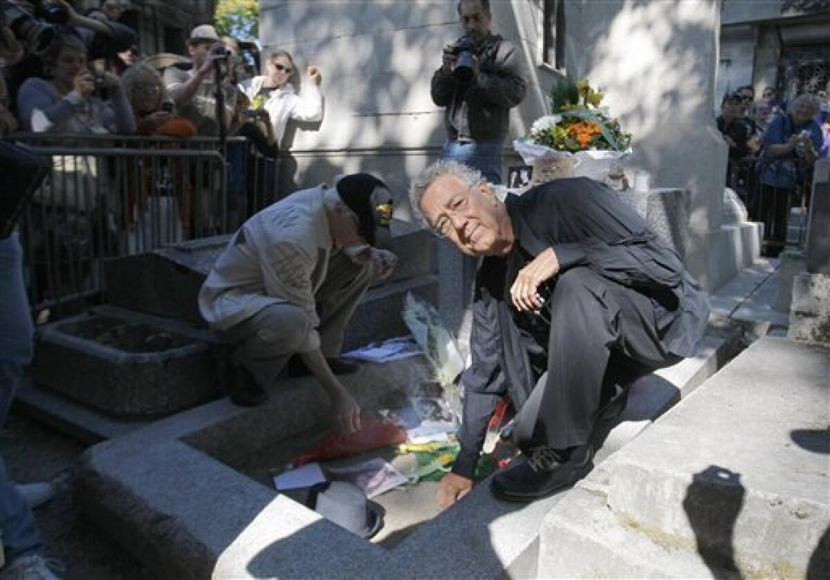 Ray Manzarek stands in front of the grave of Jim Morrison, surrounded  News Photo - Getty Images