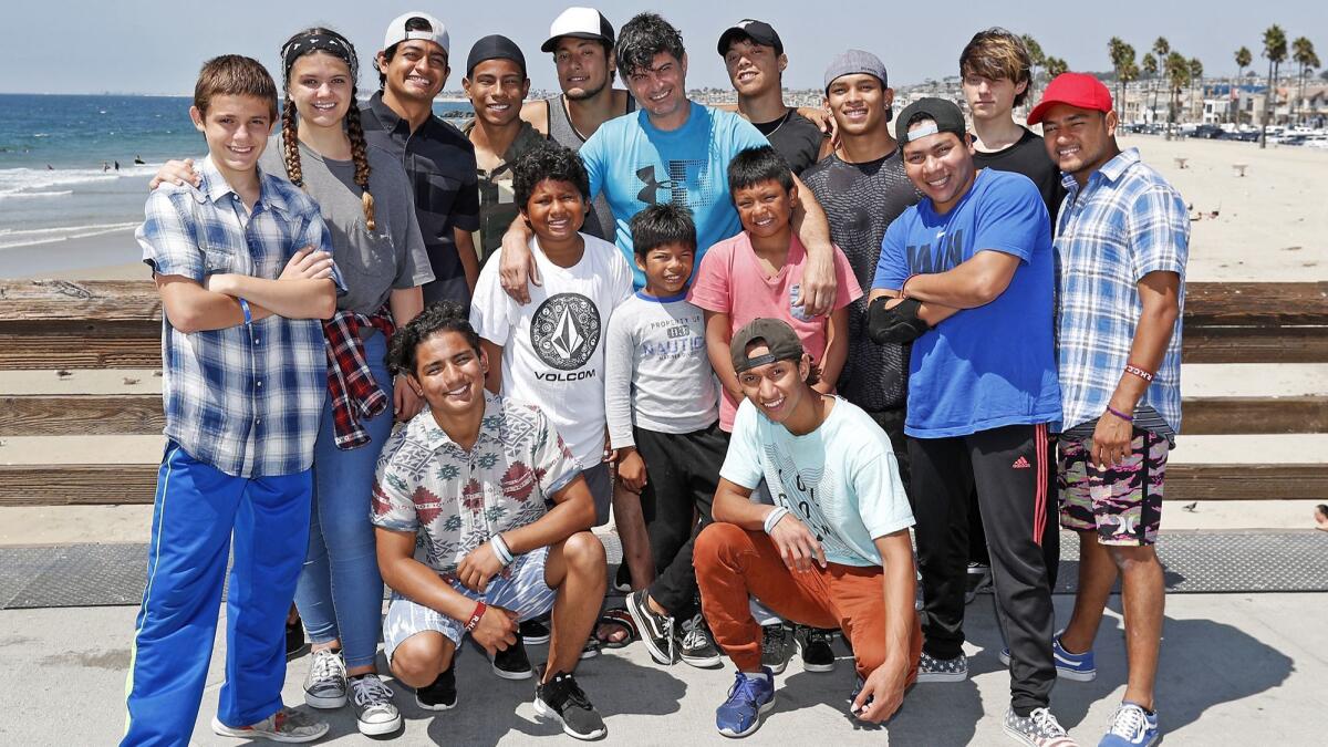 Jed Brien, top center, Capital on the Edge director, an American nonprofit, with members of Nicavangelists, a group of performers, ages 8 to 26, from Nicaragua at the Newport Pier.