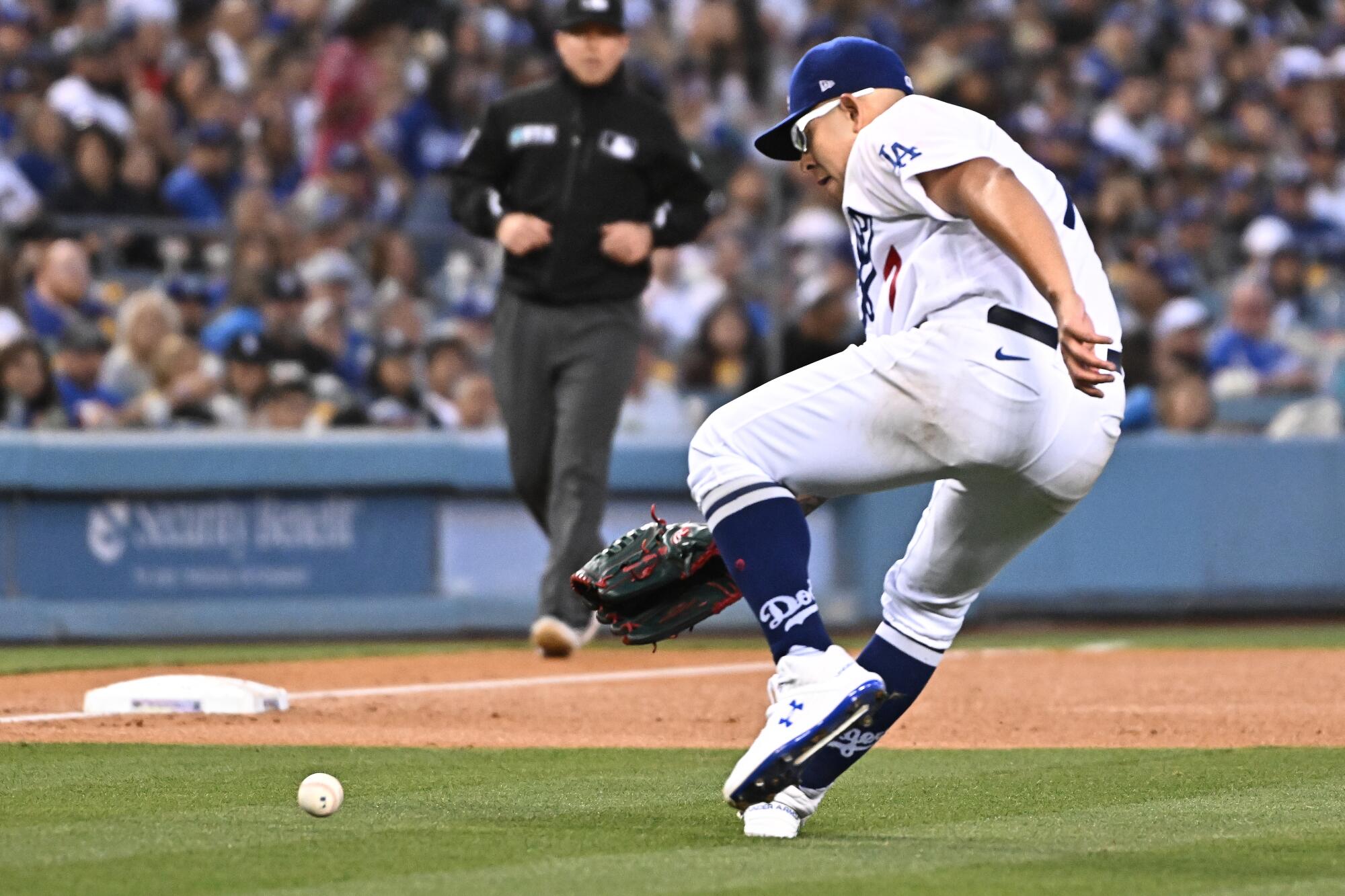 Julio Urias fields the ball on a single by Michael Chavis in the third inning.