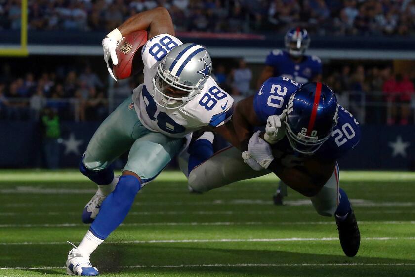 Dez Bryant (88) of the Dallas Cowboys runs after the catch as Prince Amukamara (20) of the New York Giants tries to make the tackle in the second half at AT&T Stadium on Sunday in Arlington, Texas.