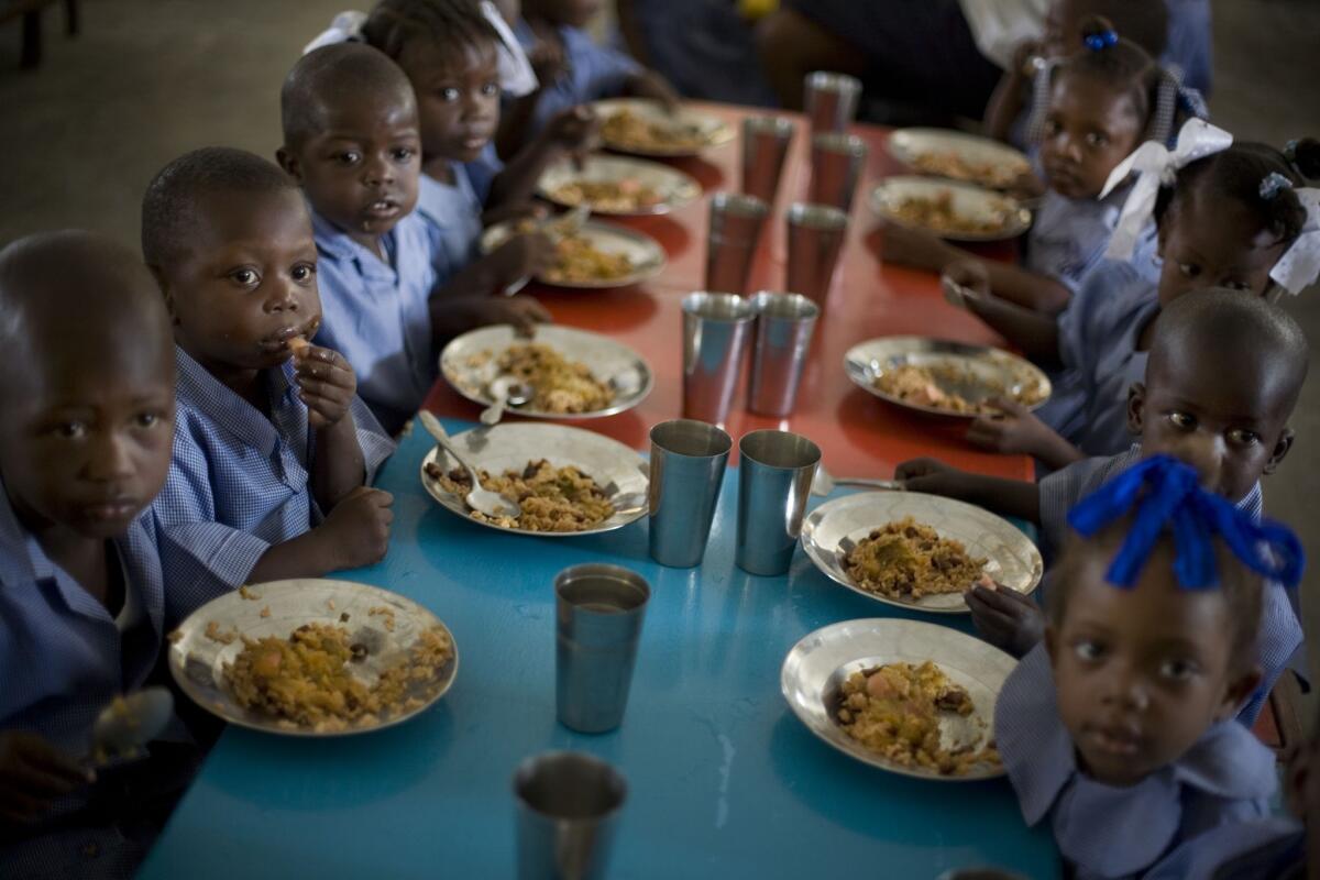Students have lunch at a school in Gonaives, Haiti, in 2009. The meals are part of a program supported by the U.N. World Food Program.