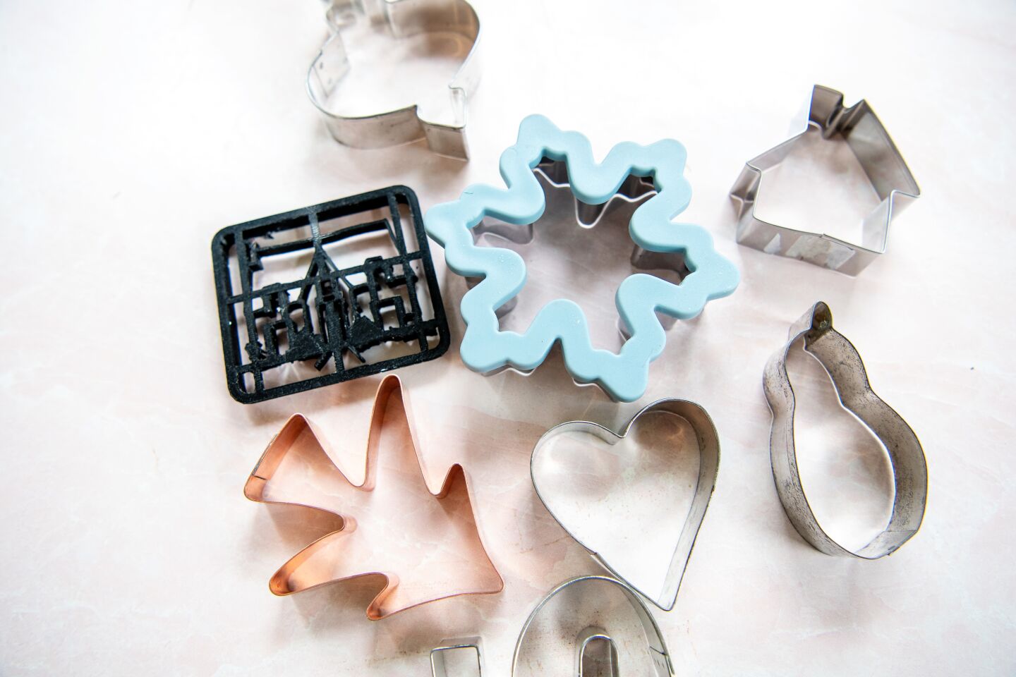 An array of festive cookie cutters includes a black one that's a replica of Saeta's 100-year-old home.