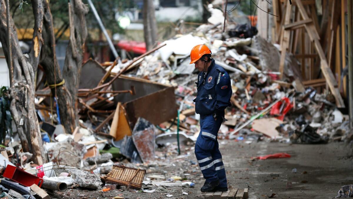A rescue worker walks amid the rubble of a collapsed building in Mexico City on Oct. 2, 2017.